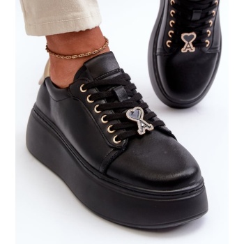 women`s leather sneakers on a black σε προσφορά