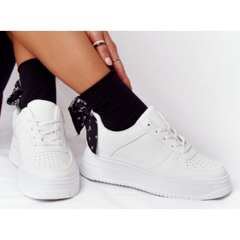 women`s sport shoes on a platform white
